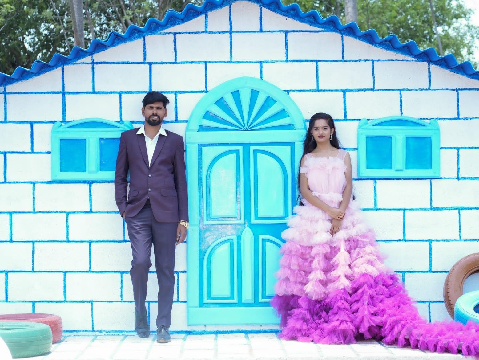 A couple on either side of the blue arched door