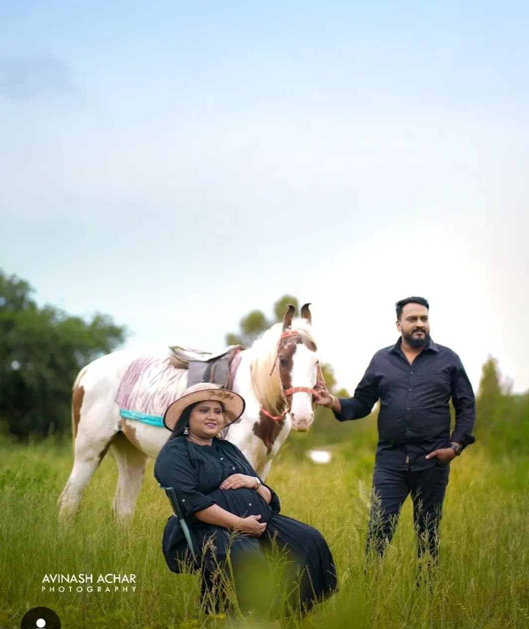 A couple in the meadow with a painted horse