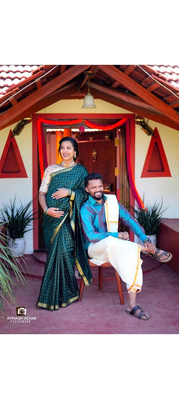 A couple in traditional dress at the cottage entrance